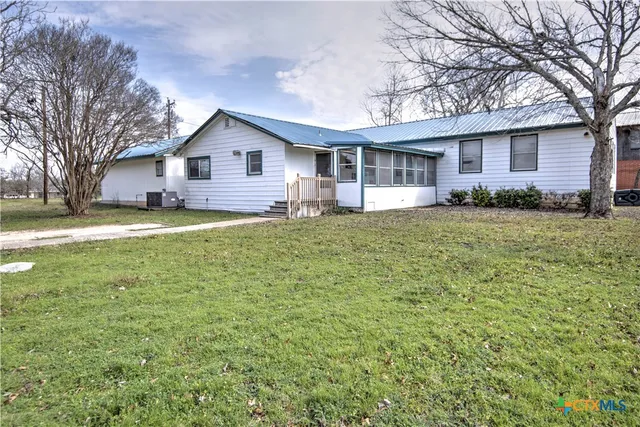 a house view with a sitting space and garden