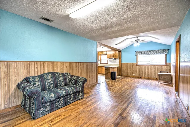 a living room with a couch and a wooden floor