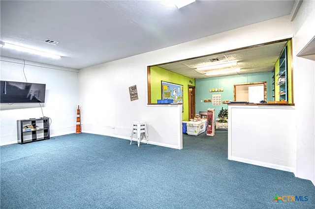 a view of a livingroom with furniture and a flat screen tv