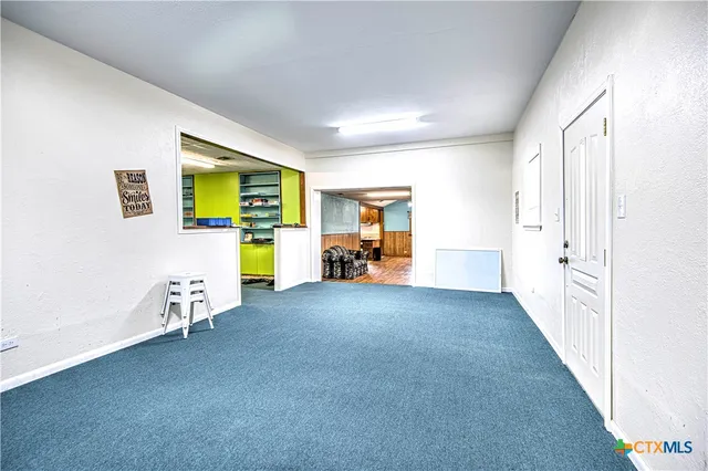 a view of a livingroom with furniture and a window