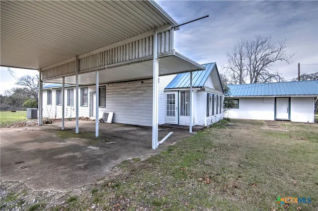 a view of a house with a yard and garage