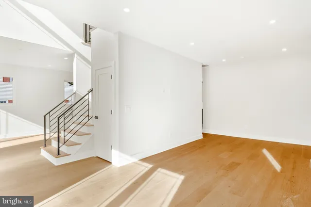 a view of an entryway with wooden floor
