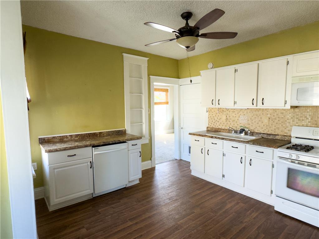 870 Chestnut Street Coplay, PA 18037 - Photo 7 of 24 A well-lit kitchen with modern flooring offers functional appliances and ample cabinetry.