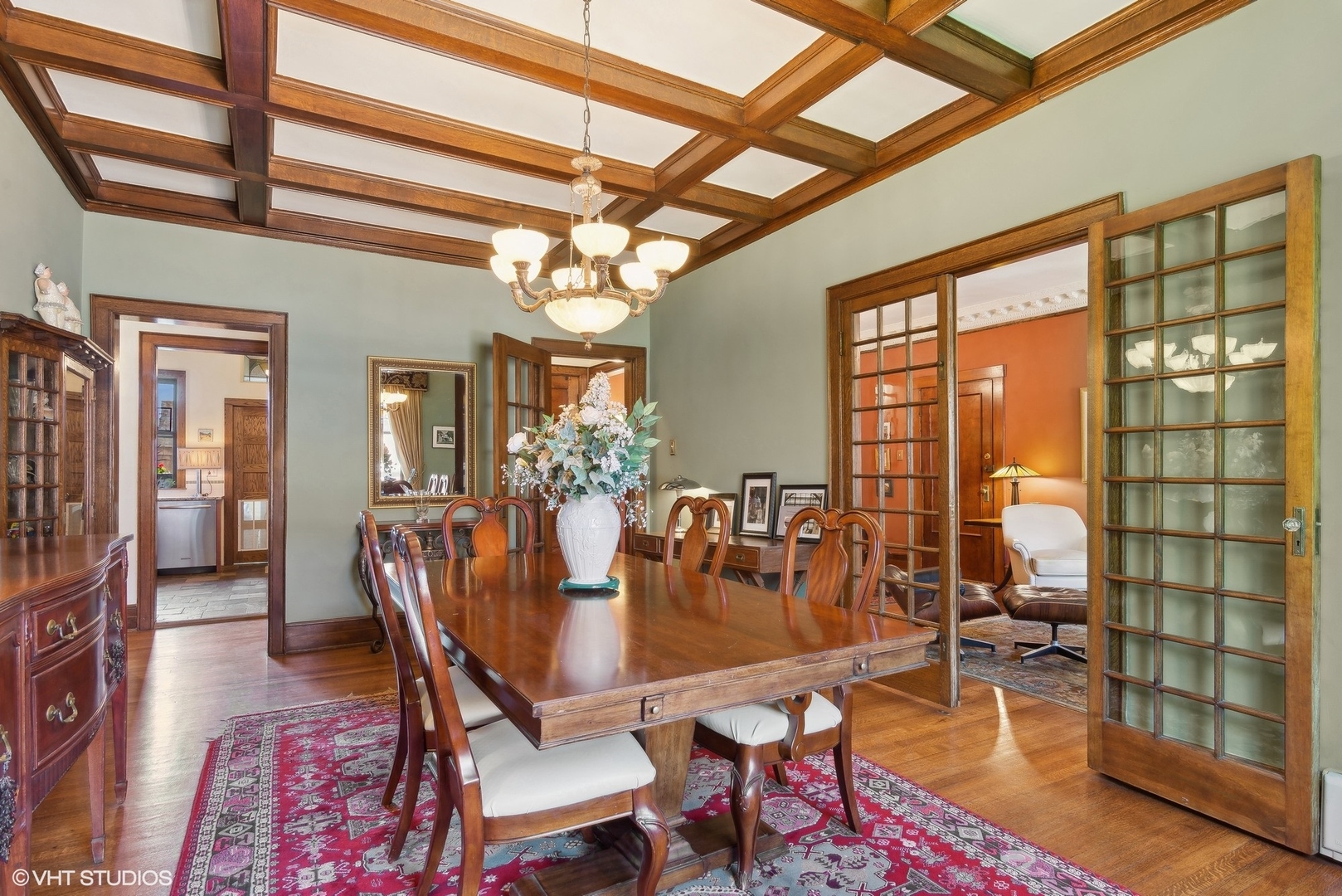 662 West Irving Park Road, Unit J4 Chicago, IL 60613 - Photo 14 of 31 a dining room with furniture a chandelier and wooden floor
