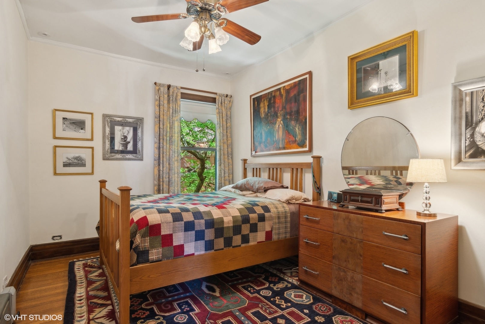 662 West Irving Park Road, Unit J4 Chicago, IL 60613 - Photo 23 of 31 a bedroom with a bed and wooden floor