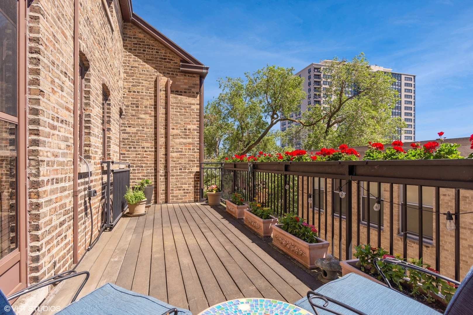 662 West Irving Park Road, Unit J4 Chicago, IL 60613 - Photo 26 of 31 a view of a balcony with wooden floor and outdoor space