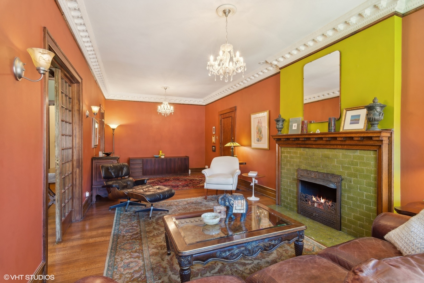 662 West Irving Park Road, Unit J4 Chicago, IL 60613 - Photo 9 of 31 a living room with furniture a chandelier and a fireplace