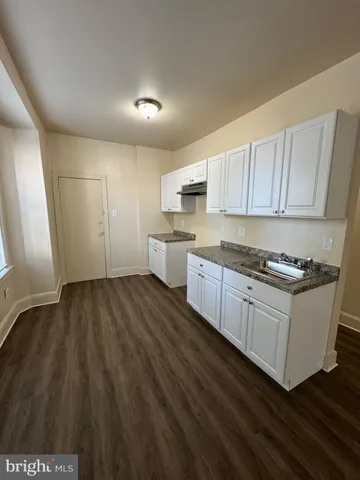 a kitchen with granite countertop a stove and a sink