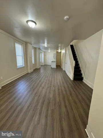 a view of a room with wooden floor and stairs
