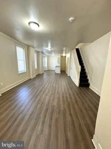 a view of a room with wooden floor and stairs