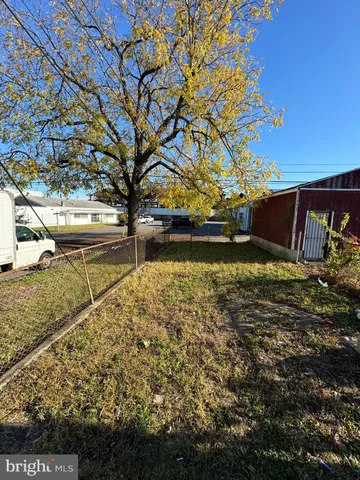 a view of backyard with wooden fence