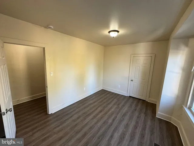 a view of hallway with wooden floor