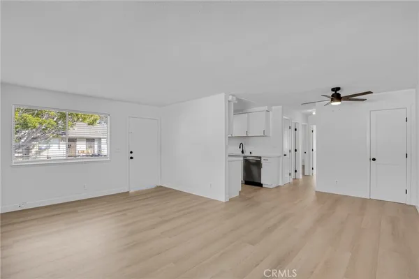 a view of a kitchen with wooden floor and windows