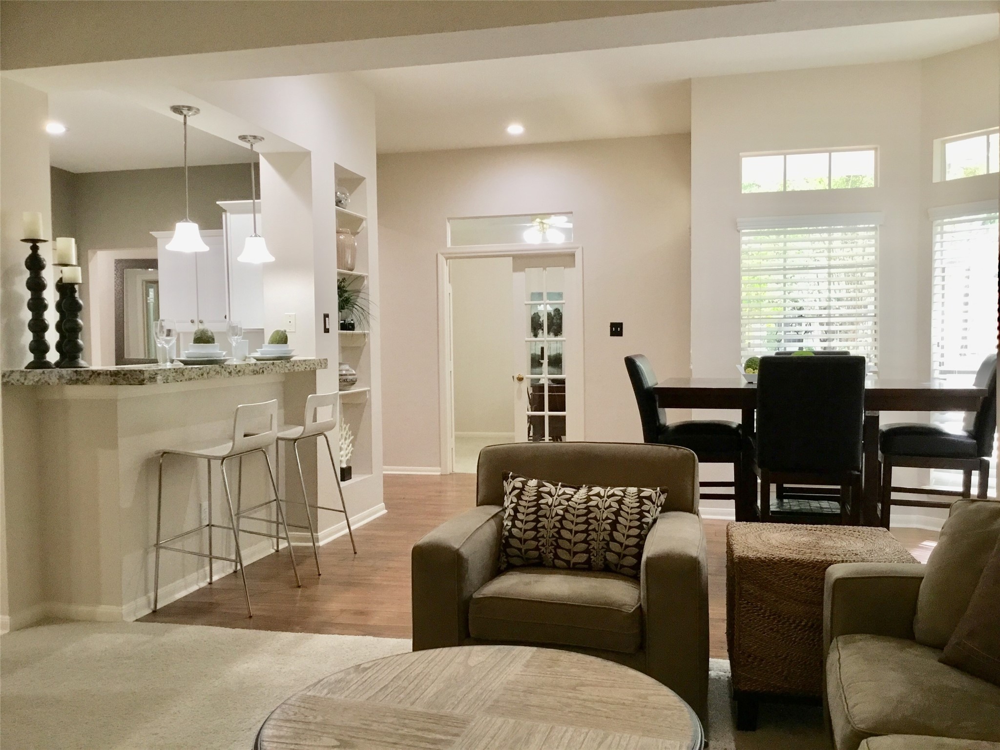 3 North Spiral Vine Circle Spring, TX 77381 - Photo 13 of 41 This inviting space features an open-concept layout with a cozy living area, a modern kitchen with a breakfast bar, and a bright dining nook. Large windows offer plenty of natural light, and the neutral tones create a warm, welcoming atmosphere.