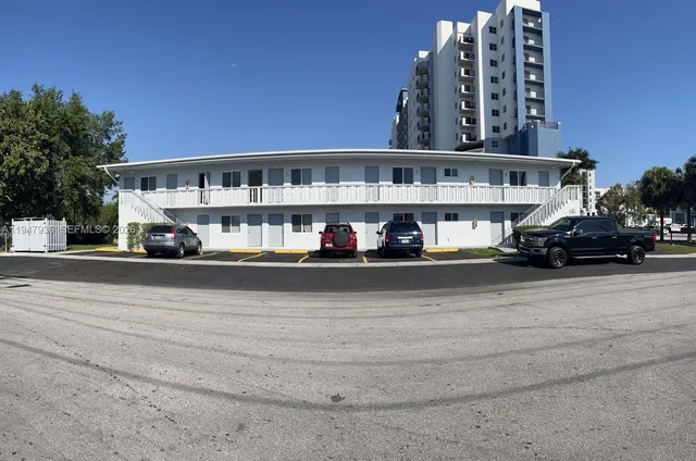 a view of building with car parked