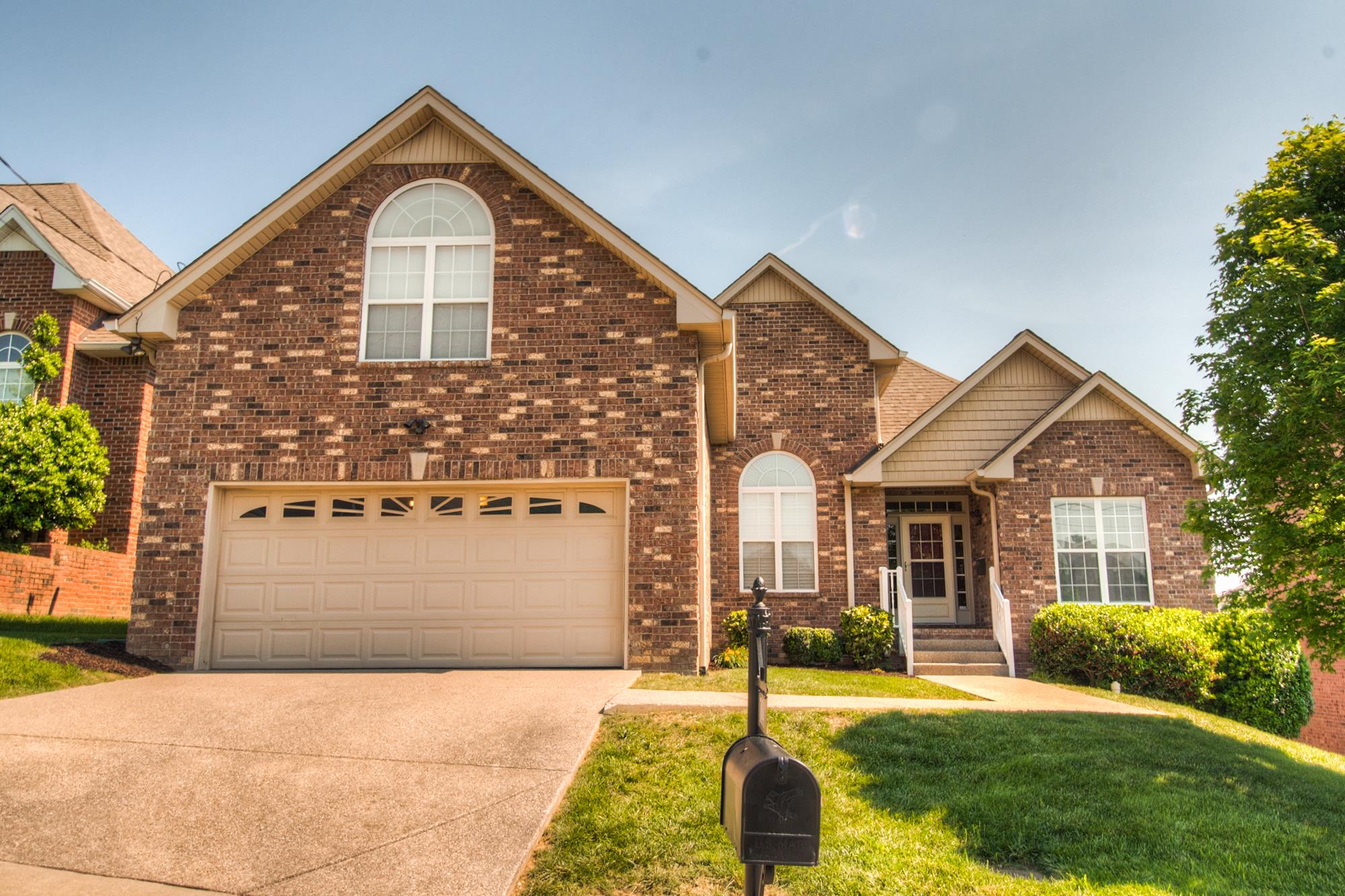 7084 Red Apple Road Antioch, TN 37013 - Photo 1 of 30 a front view of a house with a yard