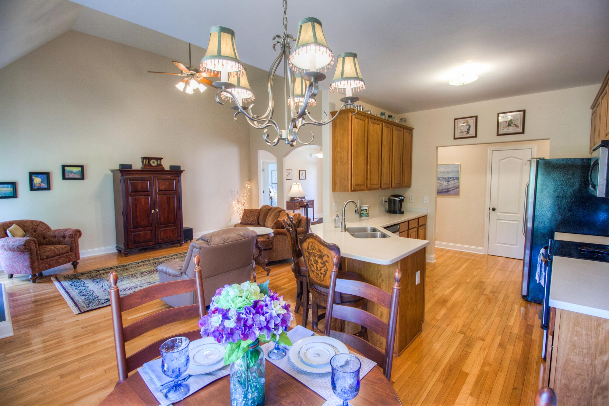7084 Red Apple Road Antioch, TN 37013 - Photo 11 of 30 a very nice looking dining room with kitchen island granite countertop furniture and a chandelier
