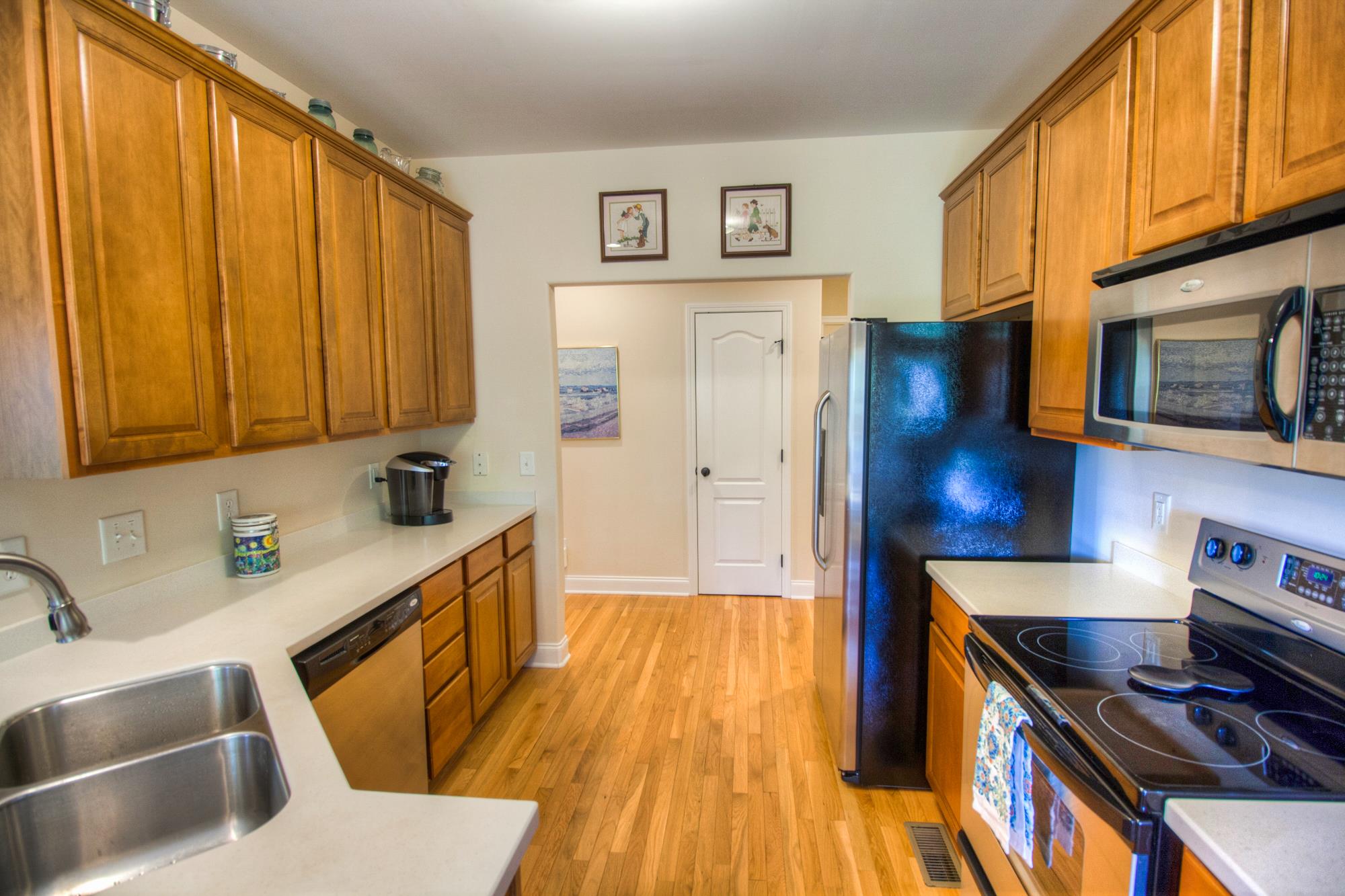 7084 Red Apple Road Antioch, TN 37013 - Photo 12 of 30 a kitchen with wooden floors and sink