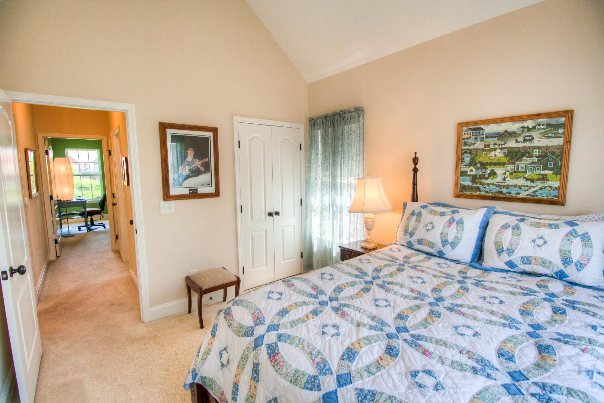 7084 Red Apple Road Antioch, TN 37013 - Photo 20 of 30 a bedroom with a large bed and a painting on the wall