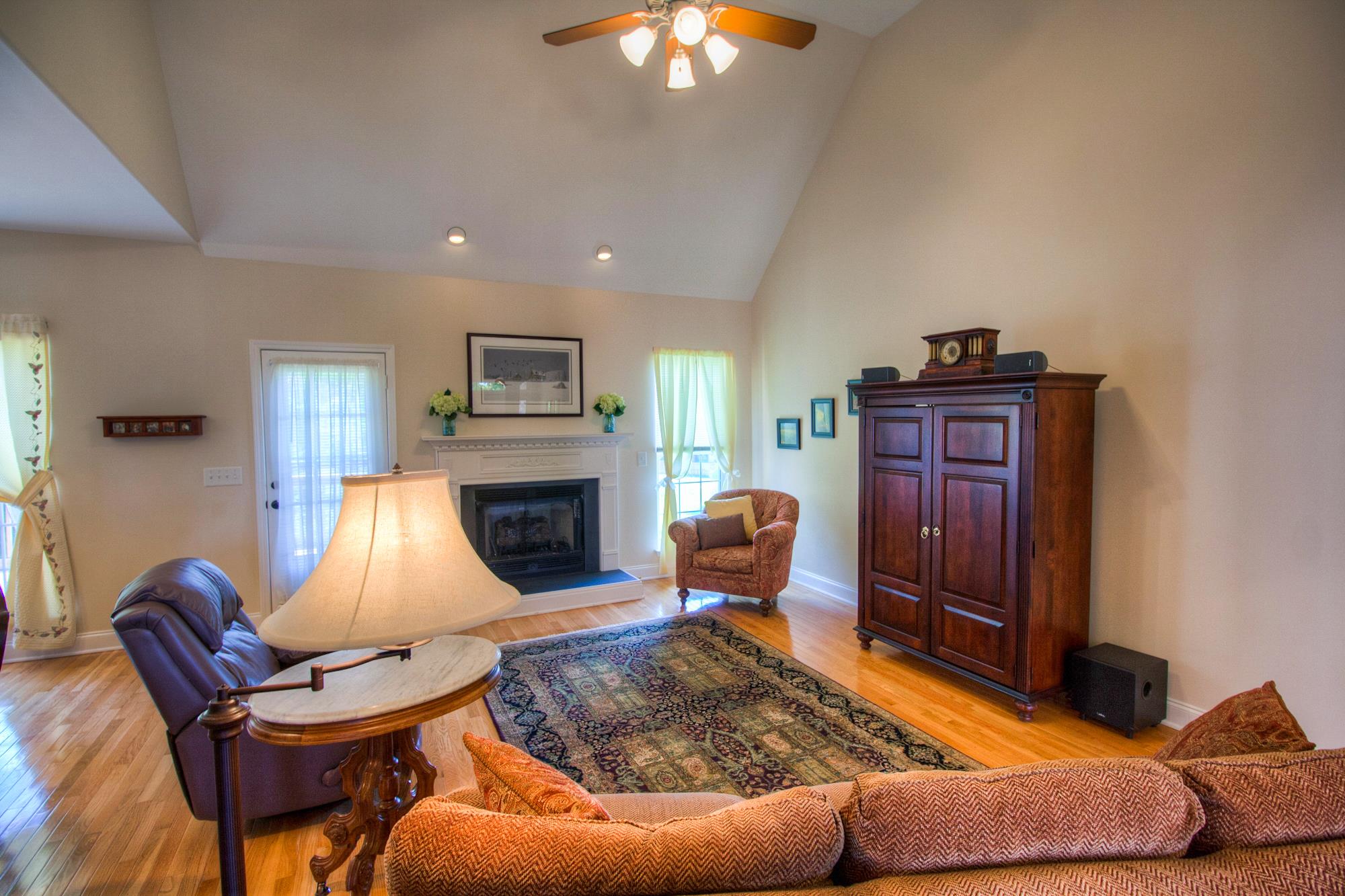 7084 Red Apple Road Antioch, TN 37013 - Photo 5 of 30 a living room with furniture a fireplace and a chandelier