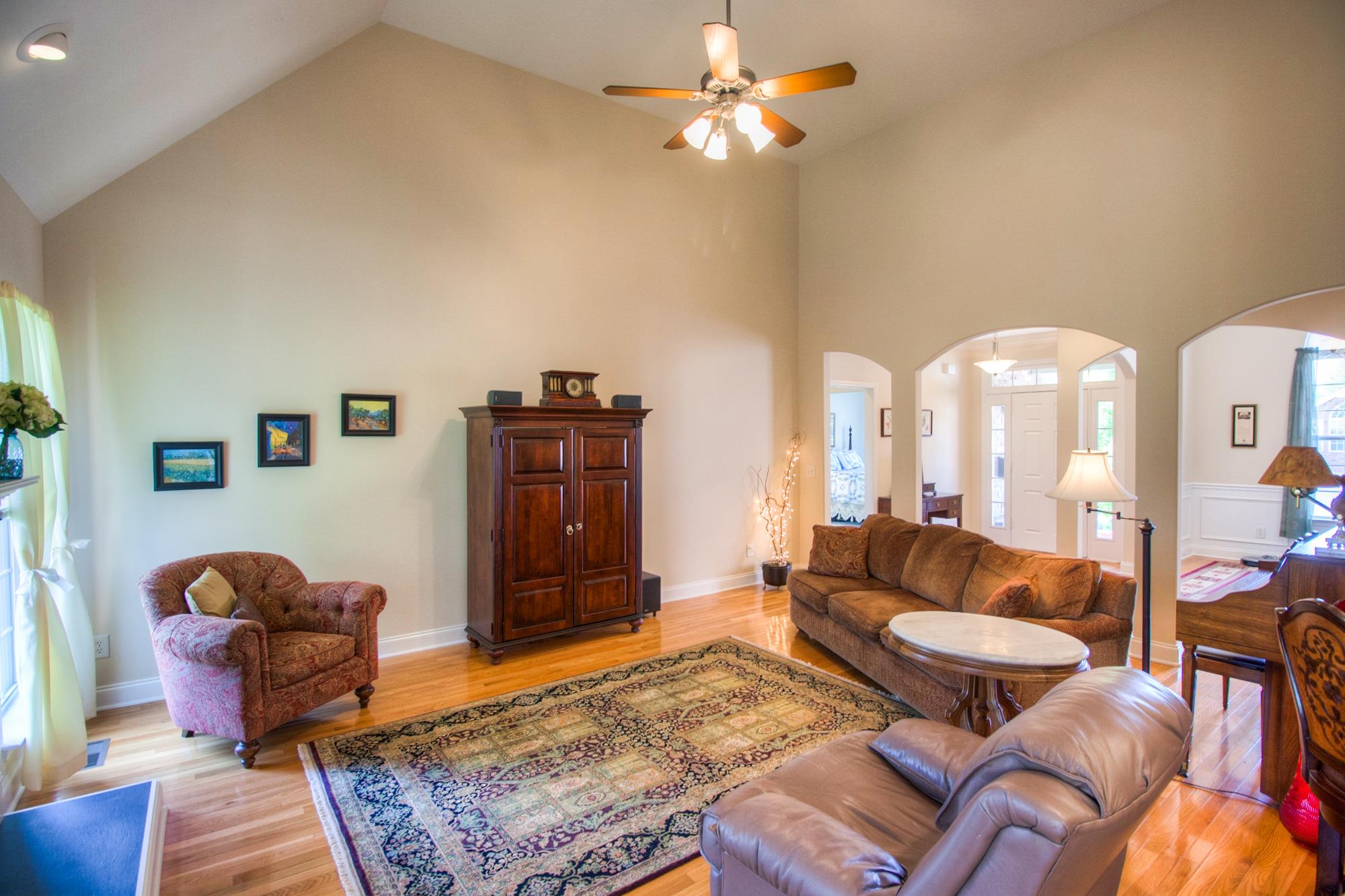 7084 Red Apple Road Antioch, TN 37013 - Photo 7 of 30 a living room with furniture a rug and a chandelier