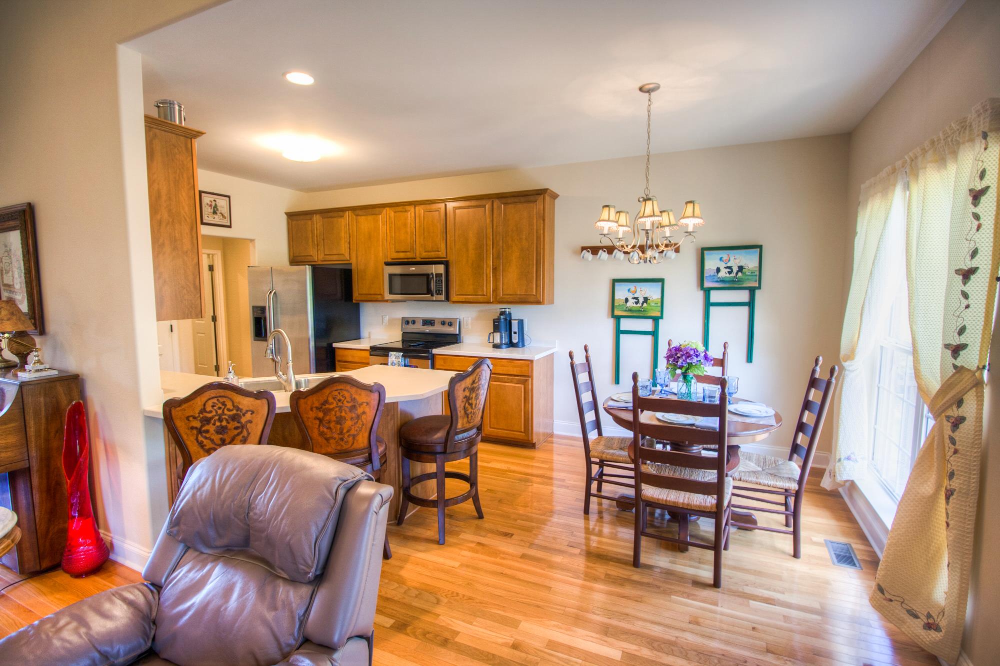 7084 Red Apple Road Antioch, TN 37013 - Photo 9 of 30 a living room with furniture a dining table and a chandelier