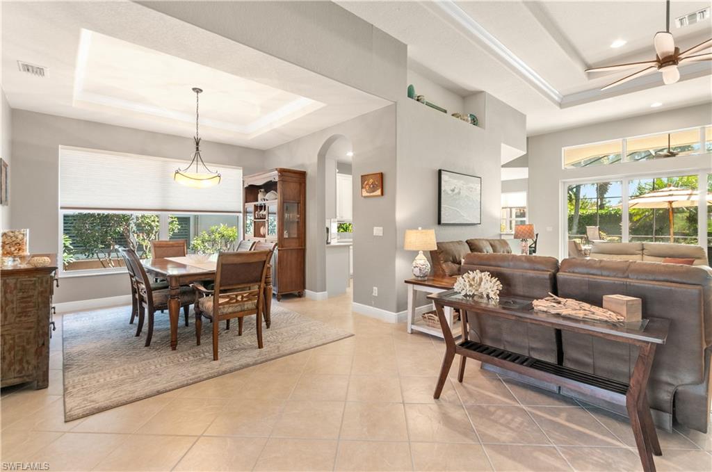 19896 Casa Verde Way Estero, FL 33967 - Photo 25 of 48 a living room with furniture dining table and a fireplace
