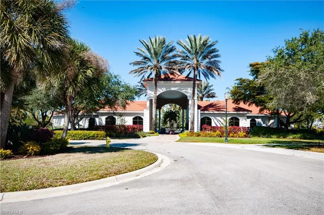 a front view of a house with a garden and plants