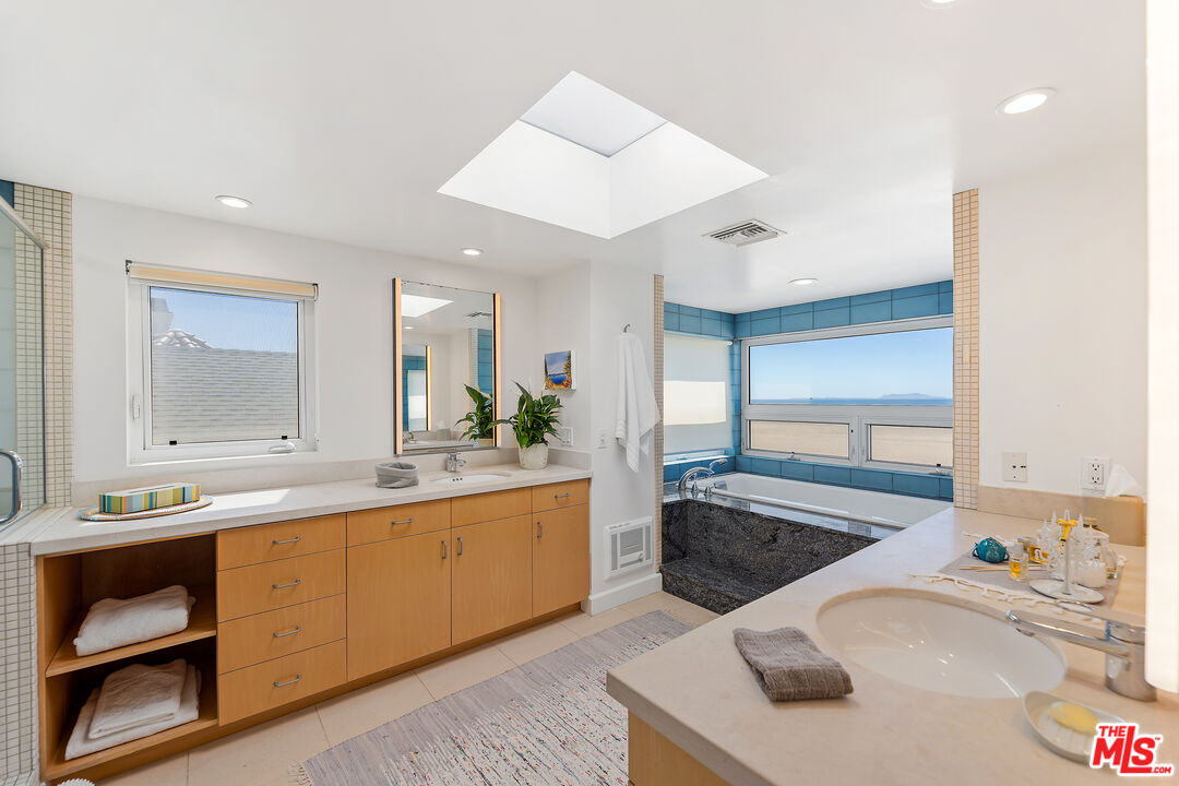 3741 Ocean Drive Oxnard, CA 93035 - Photo 15 of 29 a large kitchen with kitchen island a sink stainless steel appliances and cabinets
