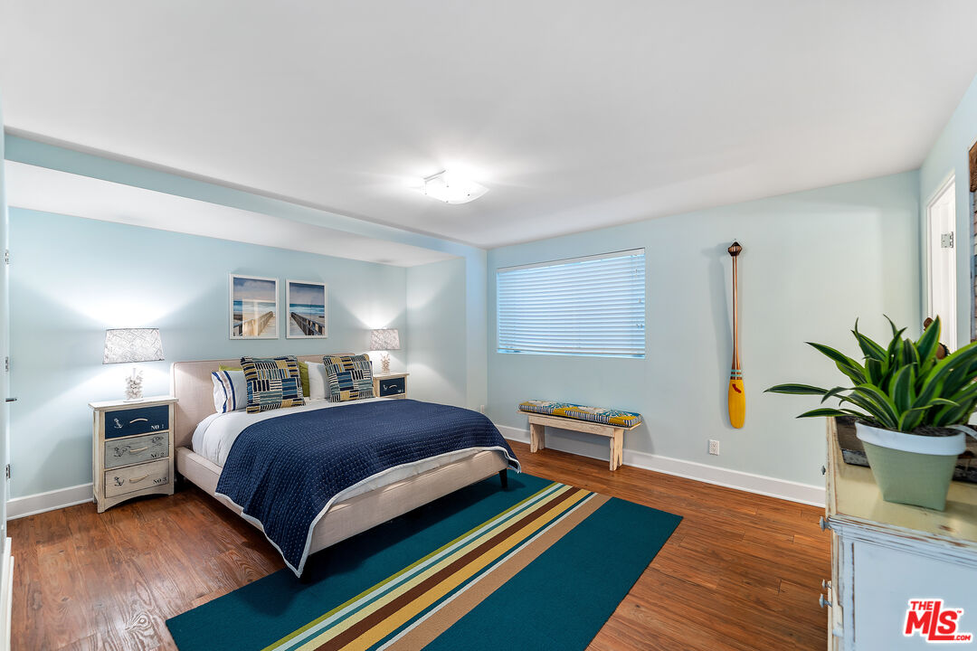 3741 Ocean Drive Oxnard, CA 93035 - Photo 25 of 29 a bedroom with a bed and wooden floor