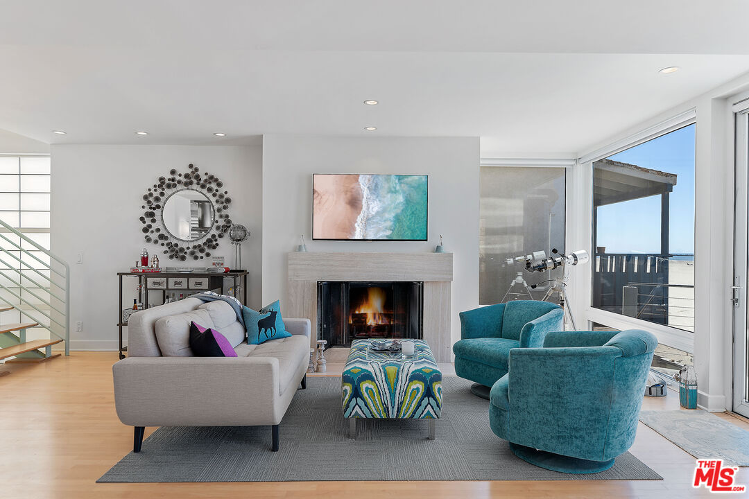 3741 Ocean Drive Oxnard, CA 93035 - Photo 6 of 29 a living room with furniture and a fireplace