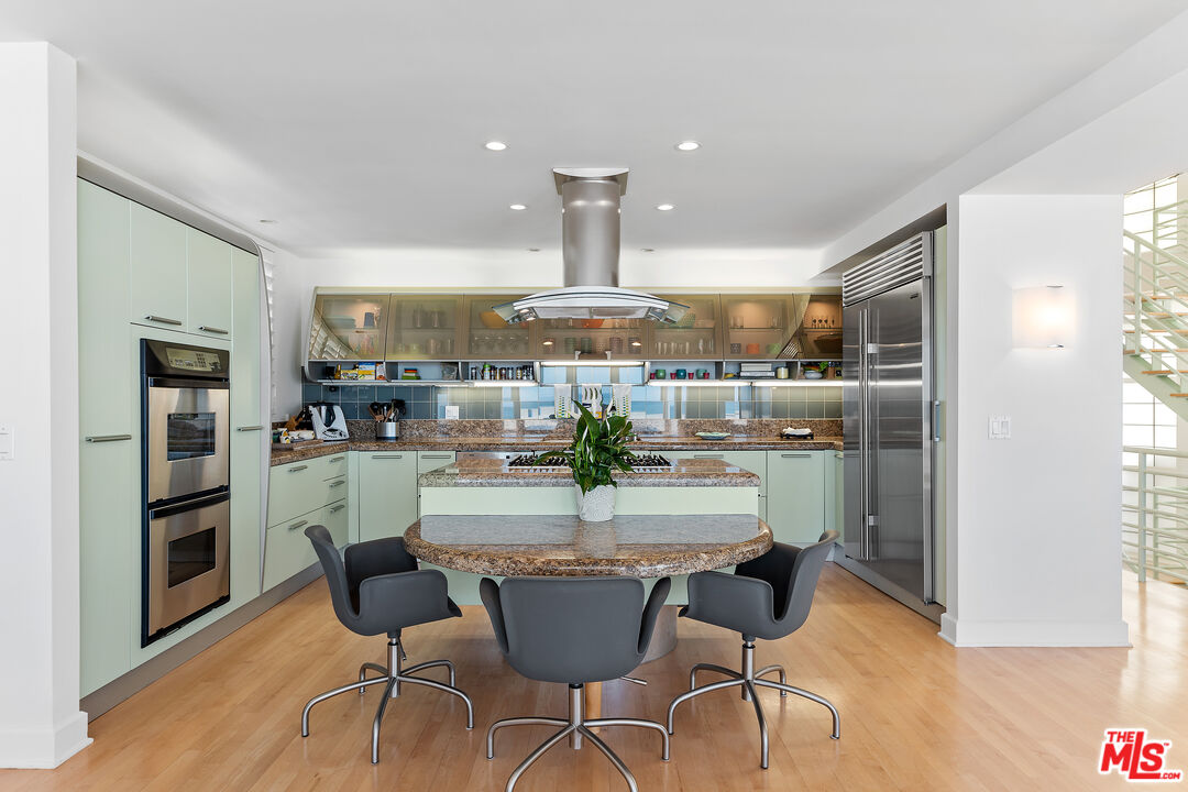 3741 Ocean Drive Oxnard, CA 93035 - Photo 9 of 29 a dining room with stainless steel appliances kitchen island granite countertop a refrigerator and a view of living room