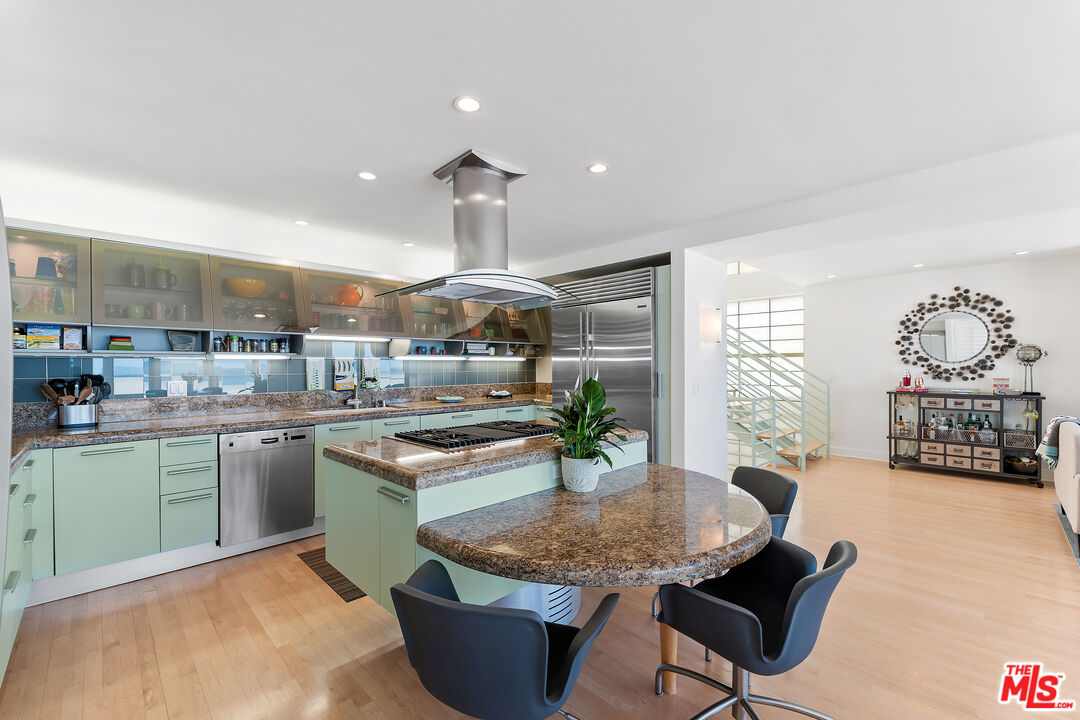 3741 Ocean Drive Oxnard, CA 93035 - Photo 10 of 29 a kitchen with stainless steel appliances granite countertop a stove and a view of living room