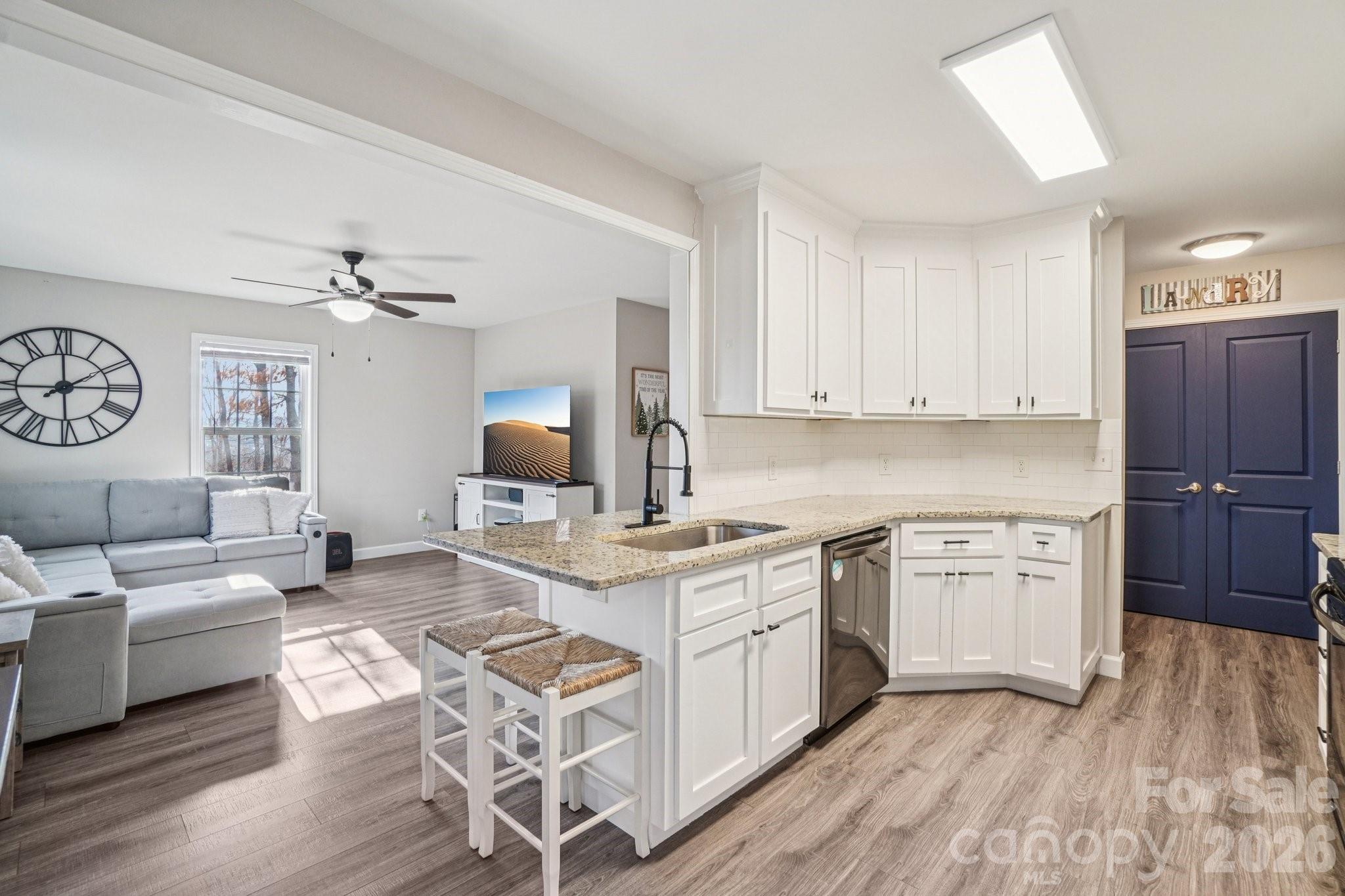 178 Rowe Court Hendersonville, NC 28792 - Photo 5 of 21 a kitchen with a stove a sink and a refrigerator