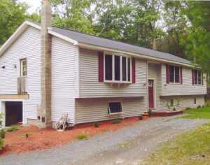 372 Raymondskill Road Milford, PA 18337 - Photo 1 of 1 a view of a house with a yard and large tree