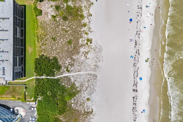 a view of a large building with a big yard and large trees