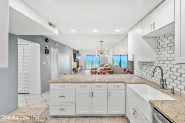 a kitchen with counter top space sink and refrigerator