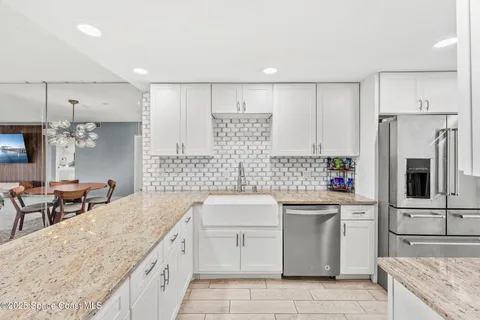 a kitchen with a sink stove and refrigerator