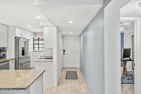 a kitchen with stainless steel appliances granite countertop a refrigerator and a sink