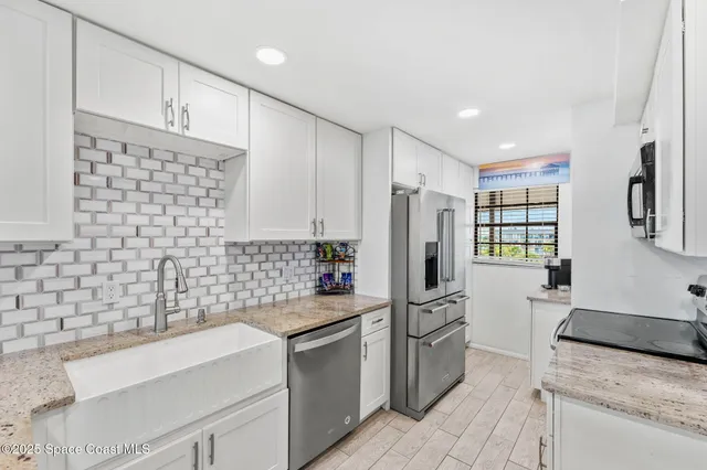 a kitchen with a refrigerator and a sink