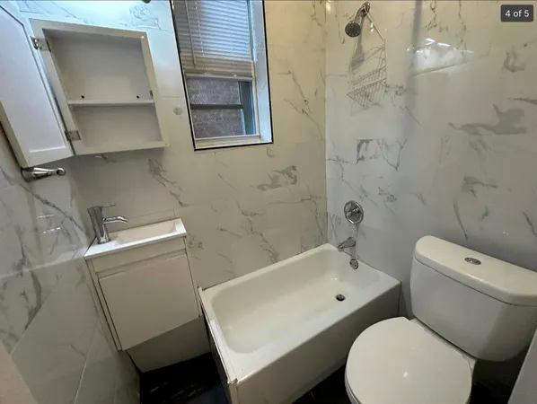 a white toilet sitting next to a bathroom sink