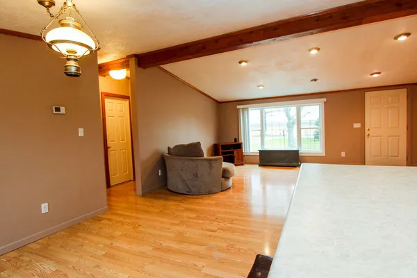 a view of a livingroom with a chandelier furniture and windows