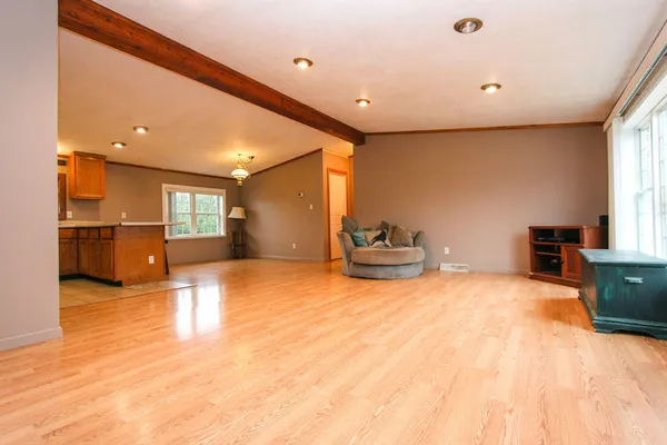a view of a livingroom with furniture and a window