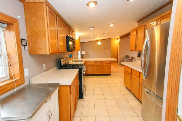 a kitchen with stainless steel appliances granite countertop a sink and cabinets