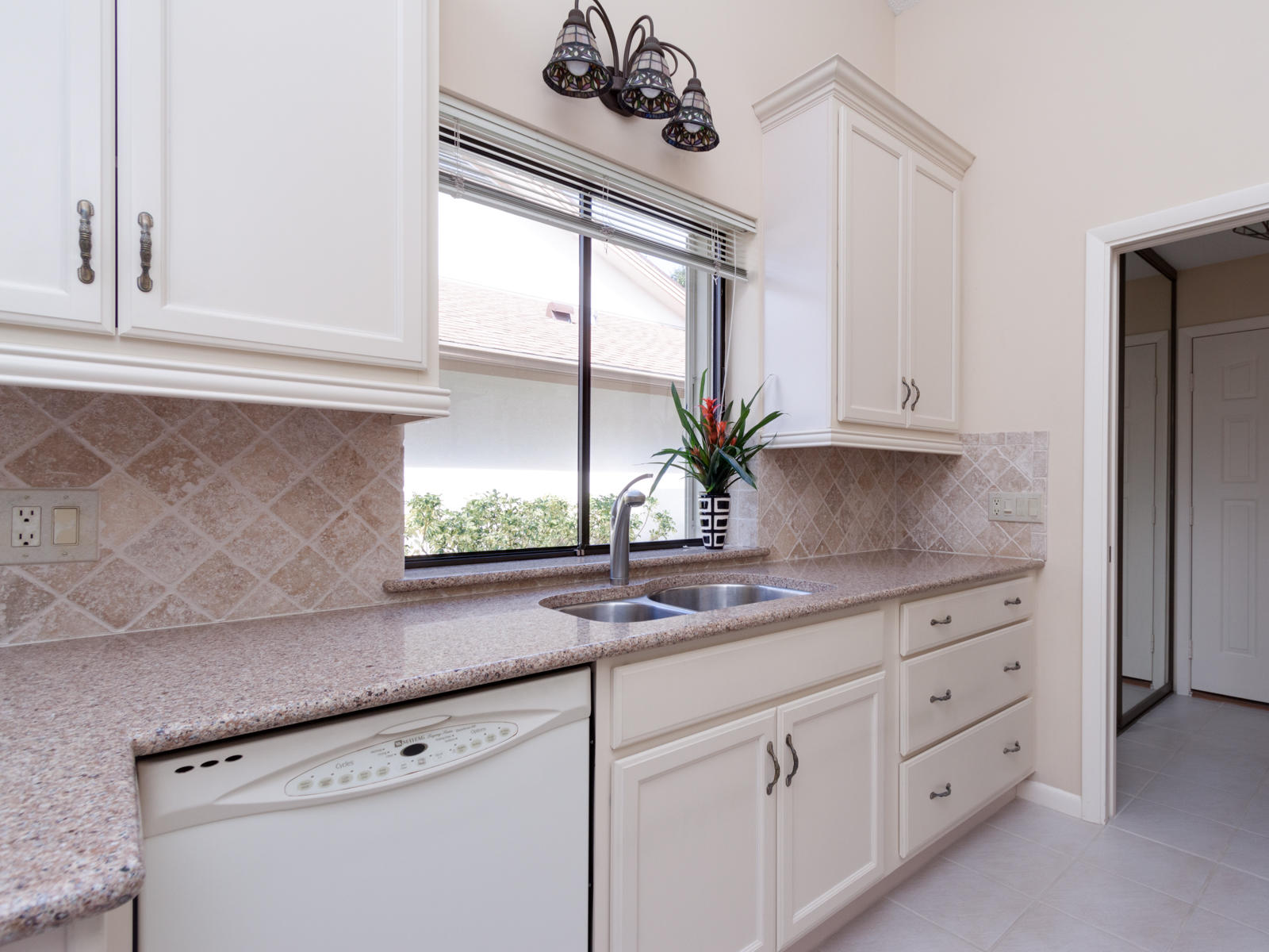 186 Ridge Road Jupiter, FL 33477 - Photo 13 of 44 a kitchen with stainless steel appliances white cabinets and a window