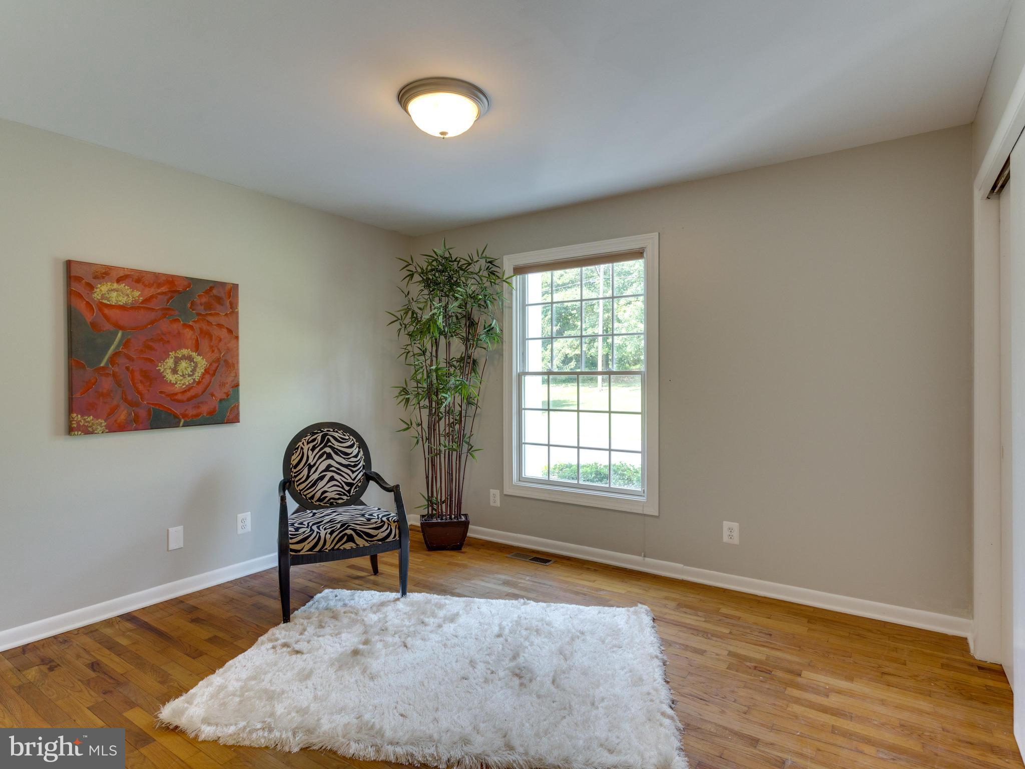 11617 Stuart Mill Road Oakton, VA 22124 - Photo 12 of 30 an empty room with windows and chair