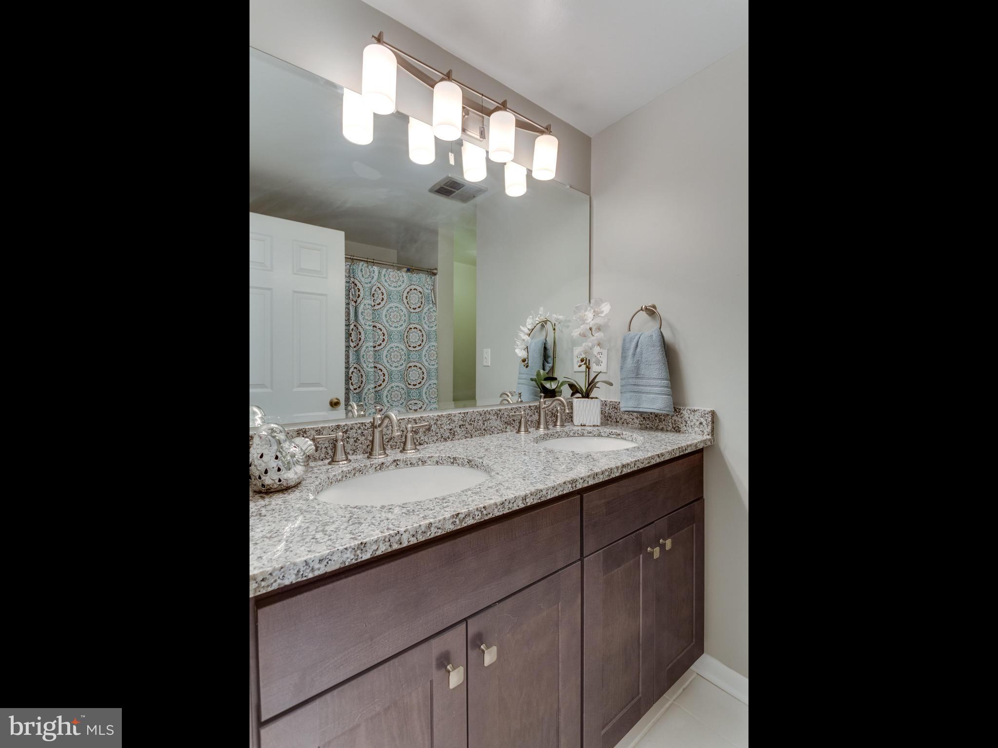 11617 Stuart Mill Road Oakton, VA 22124 - Photo 18 of 30 a bathroom with a granite countertop double vanity sink and a mirror