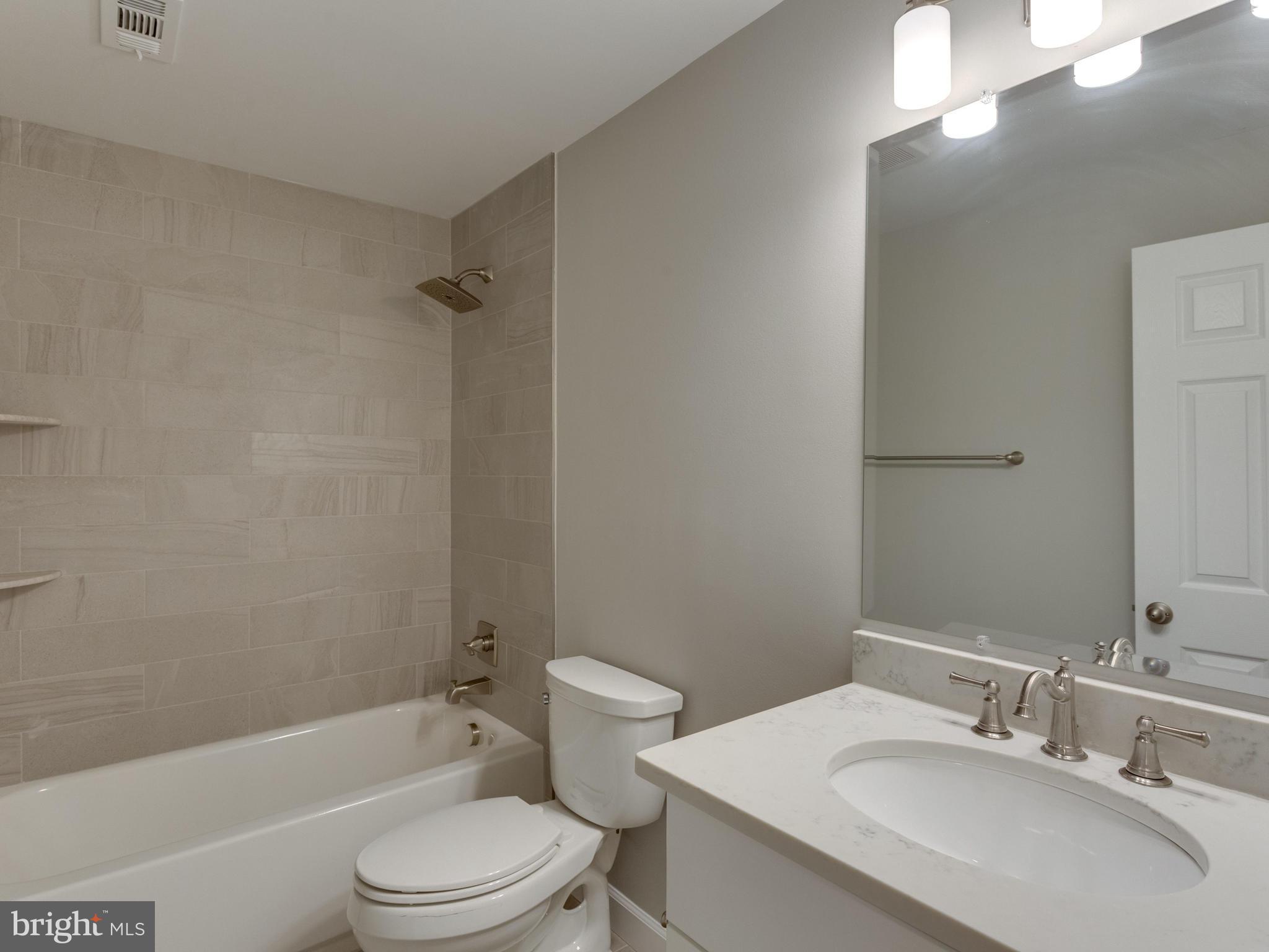 11617 Stuart Mill Road Oakton, VA 22124 - Photo 22 of 30 a bathroom with a sink toilet and shower