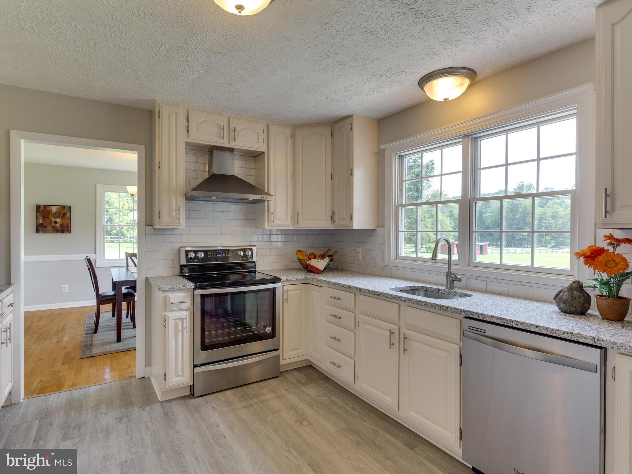 11617 Stuart Mill Road Oakton, VA 22124 - Photo 6 of 30 a kitchen with a stove a sink and a granite counter top space