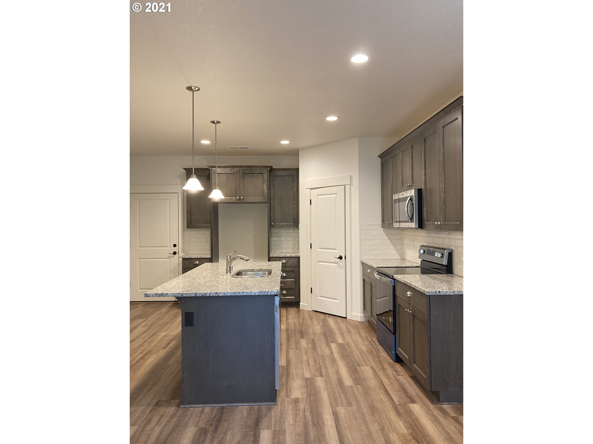 1251 South Union Place Ridgefield, WA 98642 - Photo 4 of 11 a kitchen with a sink stainless steel appliances and cabinets